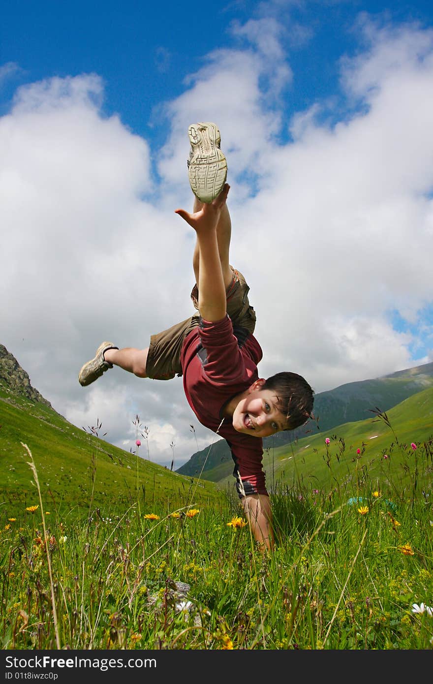 Boy dances on the meadow