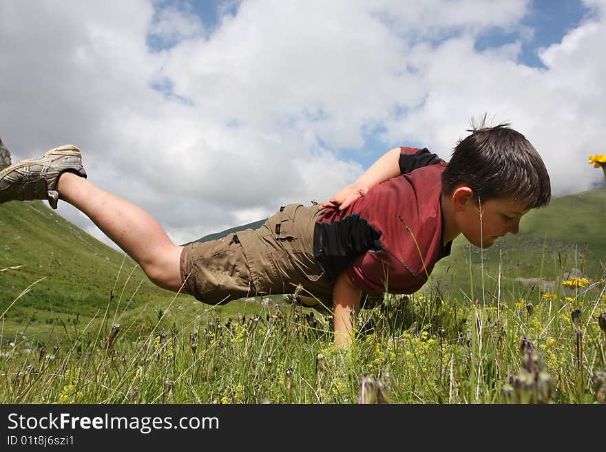 Boy dances on the meadow