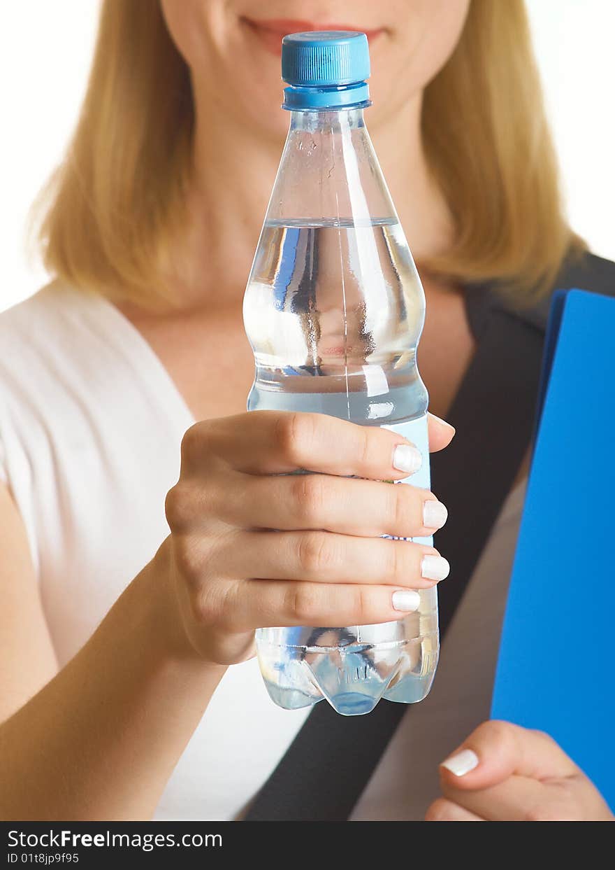 It holds a bottle with water on the white background. It holds a bottle with water on the white background