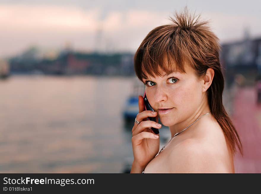 A young woman speaking on the phone. A young woman speaking on the phone