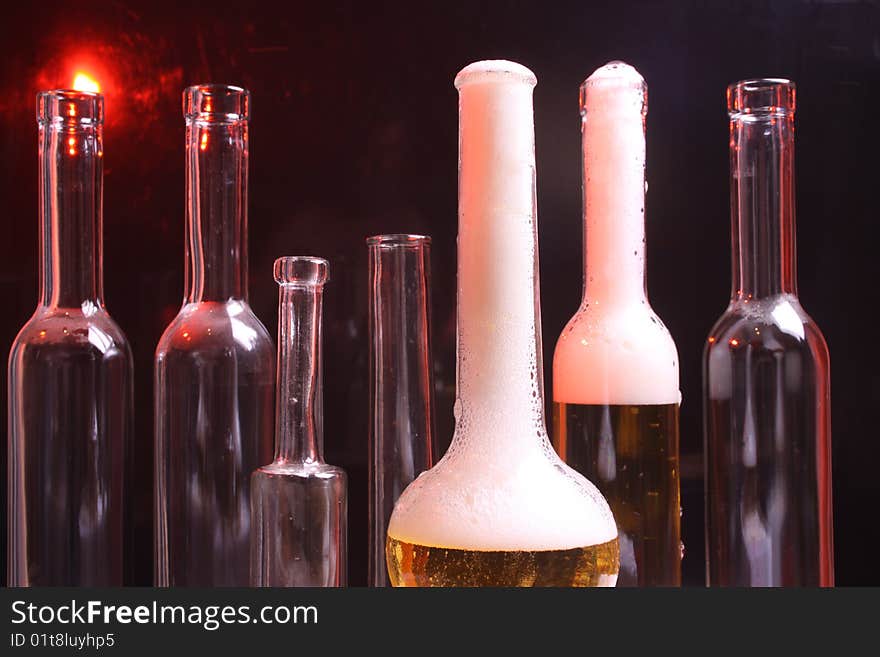 A nice set of different shaped bottles on a black background. A nice set of different shaped bottles on a black background