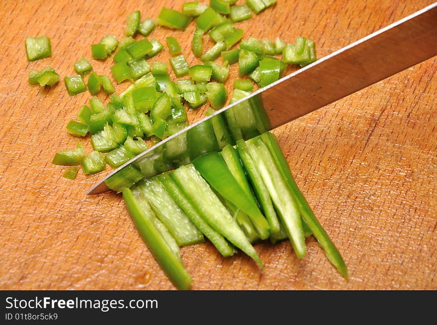 Chopping pepper with knife in small pieces. Chopping pepper with knife in small pieces.