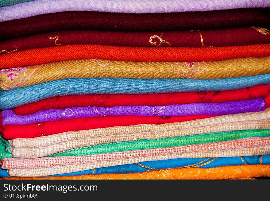 A stack of colourful embroidered Arabian Shawls. A stack of colourful embroidered Arabian Shawls