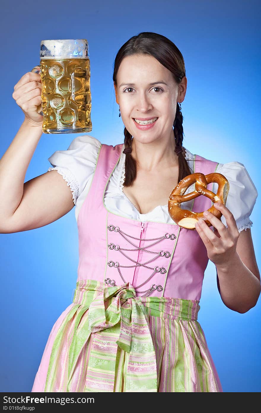 A young Bavarian girl celebrating Oktoberfest with a mass of beer. A young Bavarian girl celebrating Oktoberfest with a mass of beer