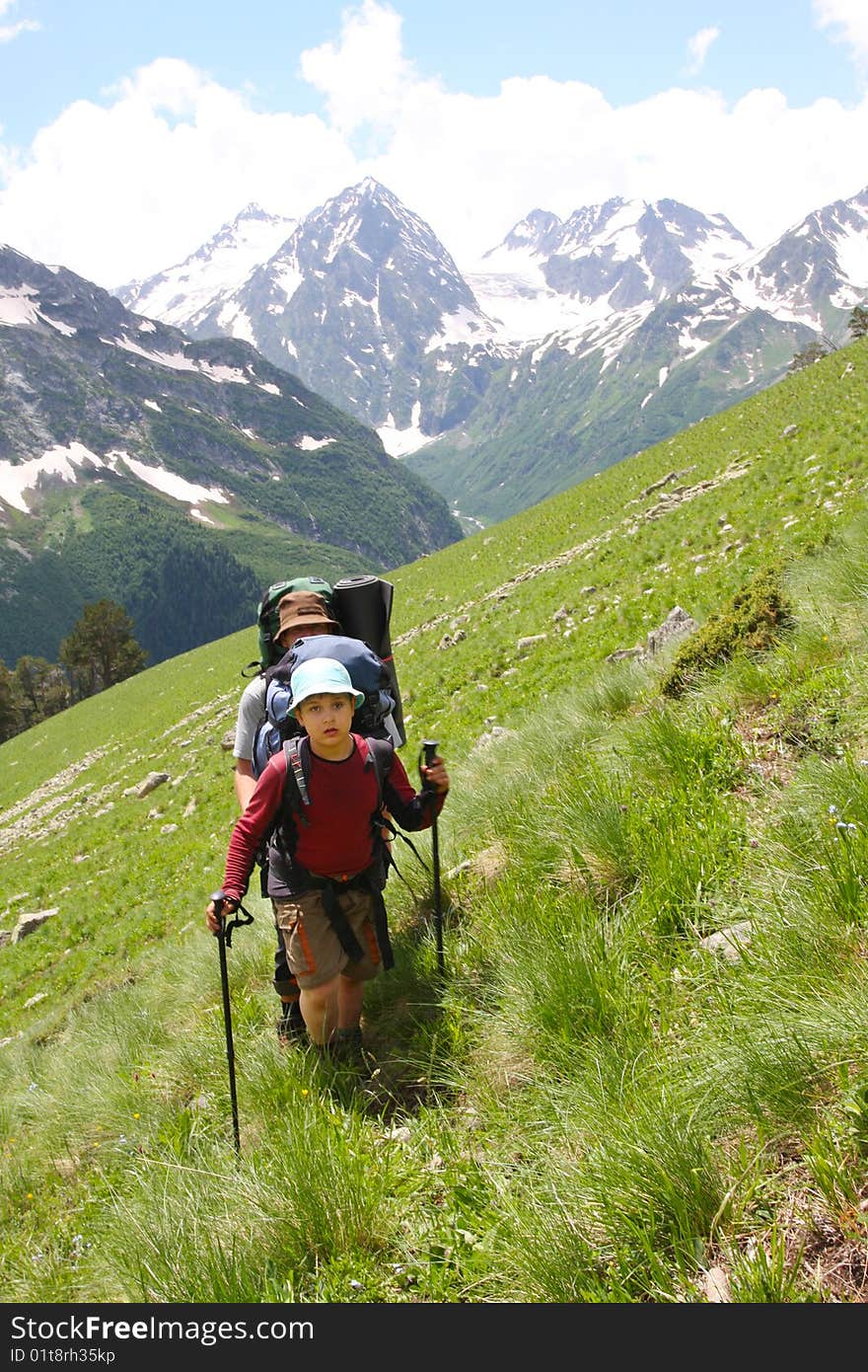 Hikers family in Caucasus mountains