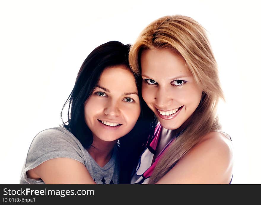 Happy beautiful young women laughing and hugging