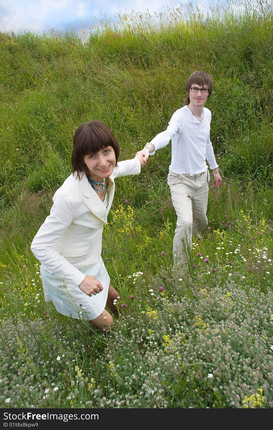 Boy and girl (couple) on meadow