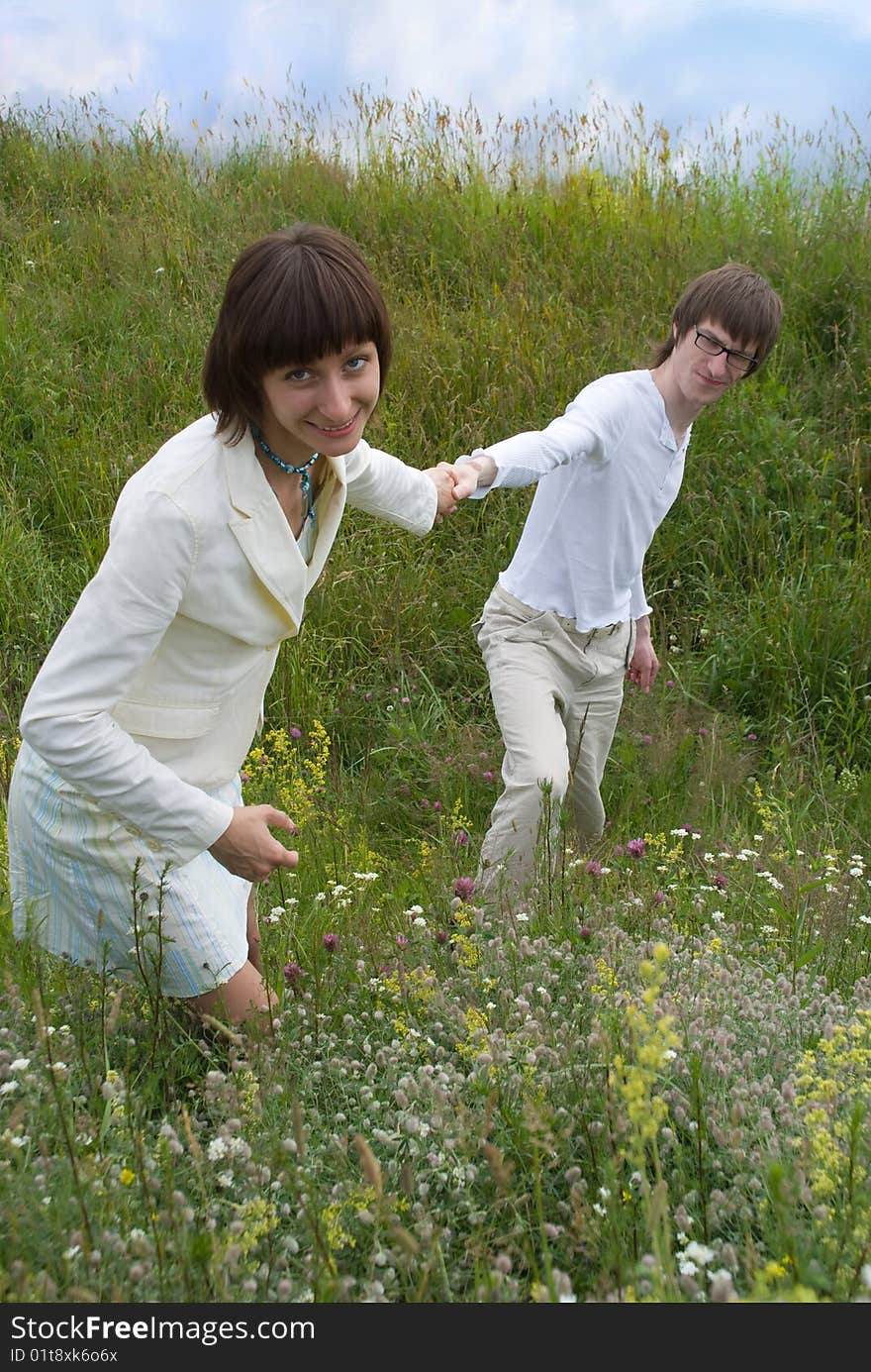 Boy and girl (couple) on meadow