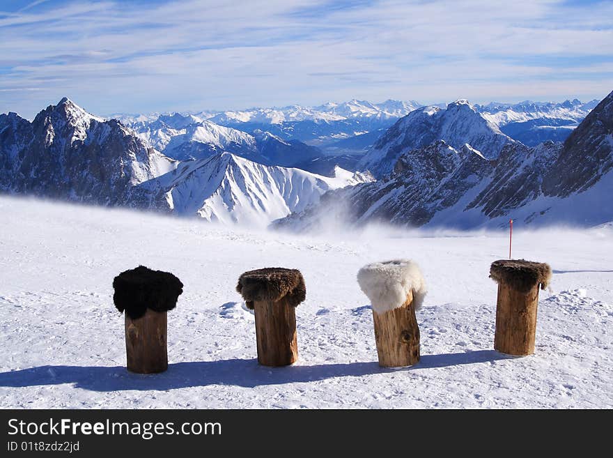 Row of stools in front of mountain panorama. Row of stools in front of mountain panorama