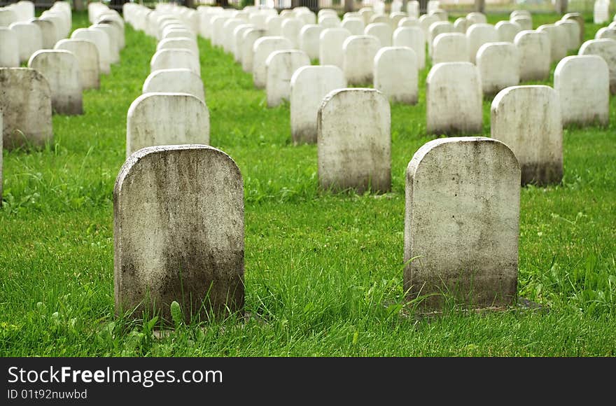 Old white tombstones in a cemetery.