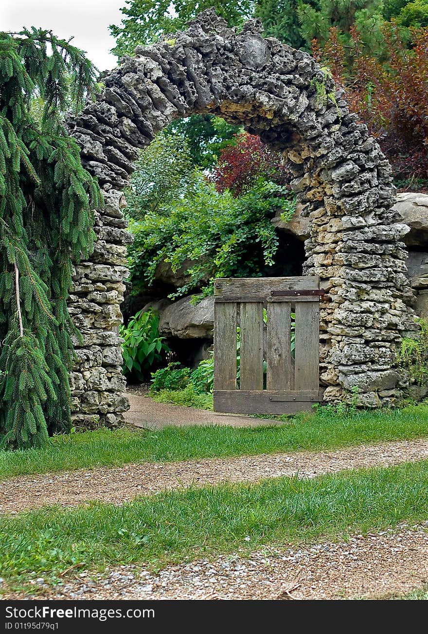 Stacked rock arch with wooden gate