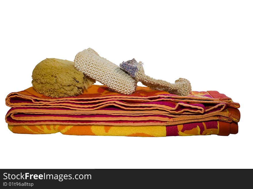 Towel, sponge and glove indicating that a spa treatment is coming. Isolated on white. Towel, sponge and glove indicating that a spa treatment is coming. Isolated on white.