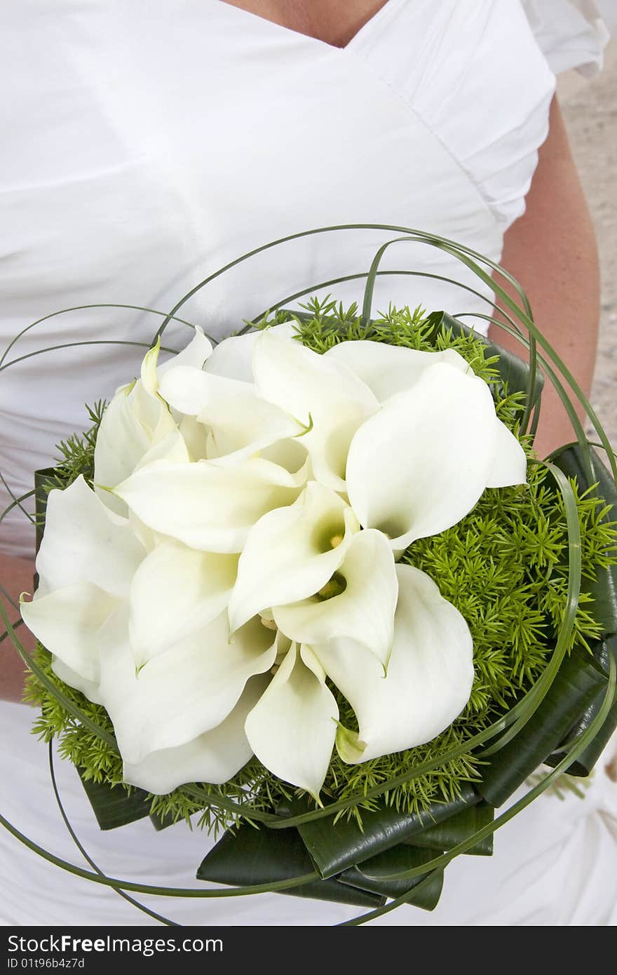 Close-up of a bridal bouquet. wedding dress in background. Close-up of a bridal bouquet. wedding dress in background.