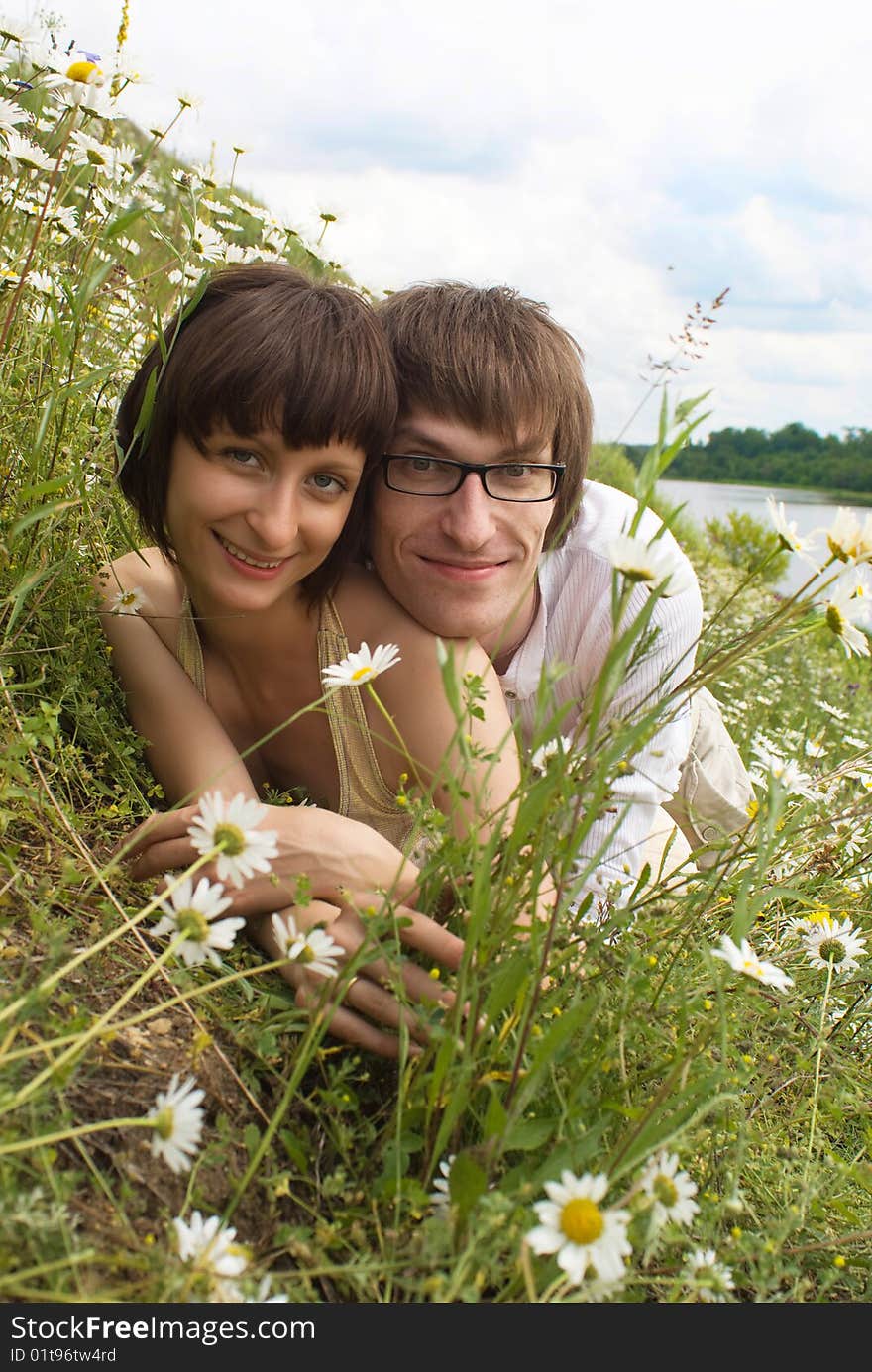 Boy and girl on a green grass. Boy and girl on a green grass