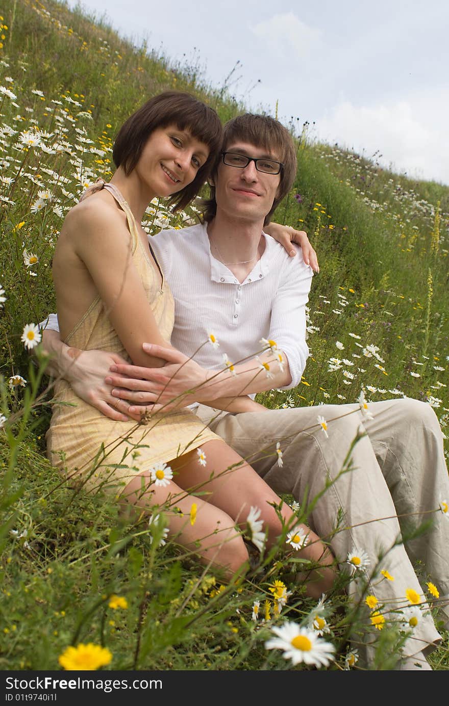 Boy and girl on a green grass. Boy and girl on a green grass