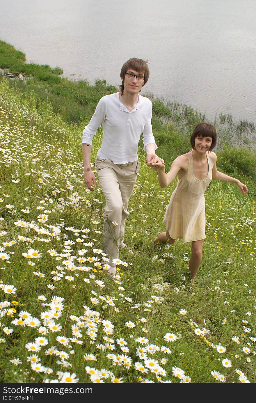 Boy and girl (couple) on meadow