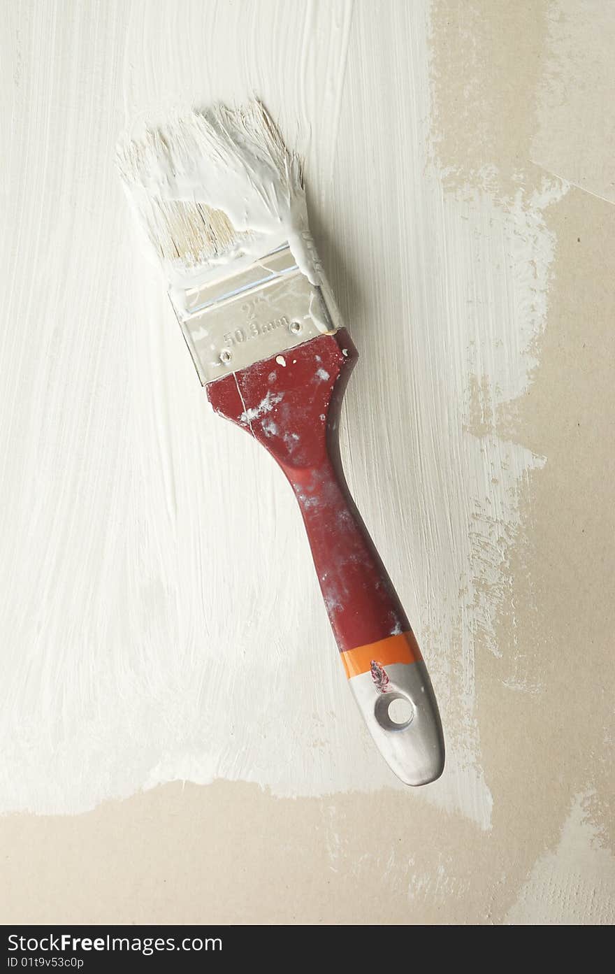 Brush in white paint on wall