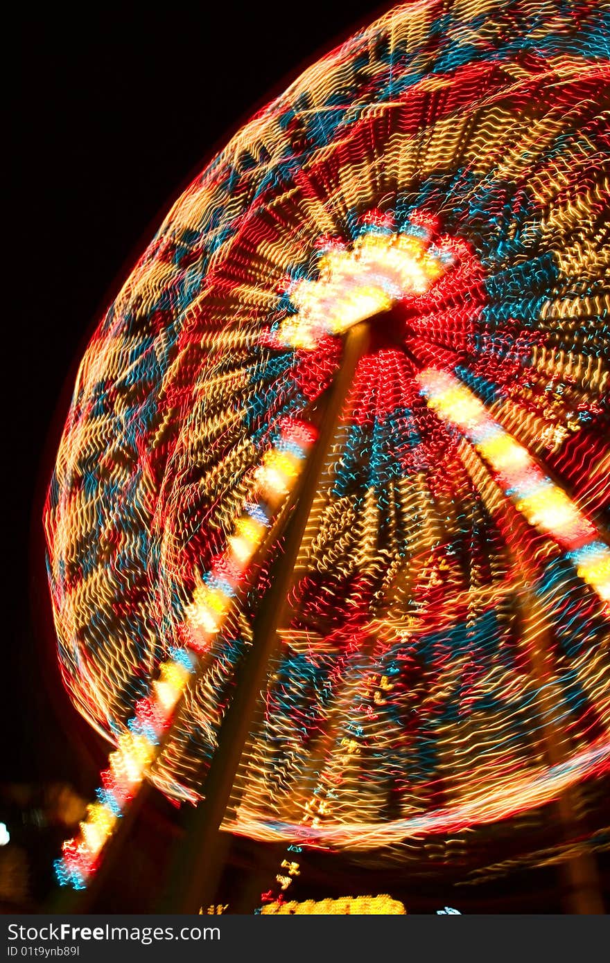 A night sot of illuminated joy wheel taken with long exposure