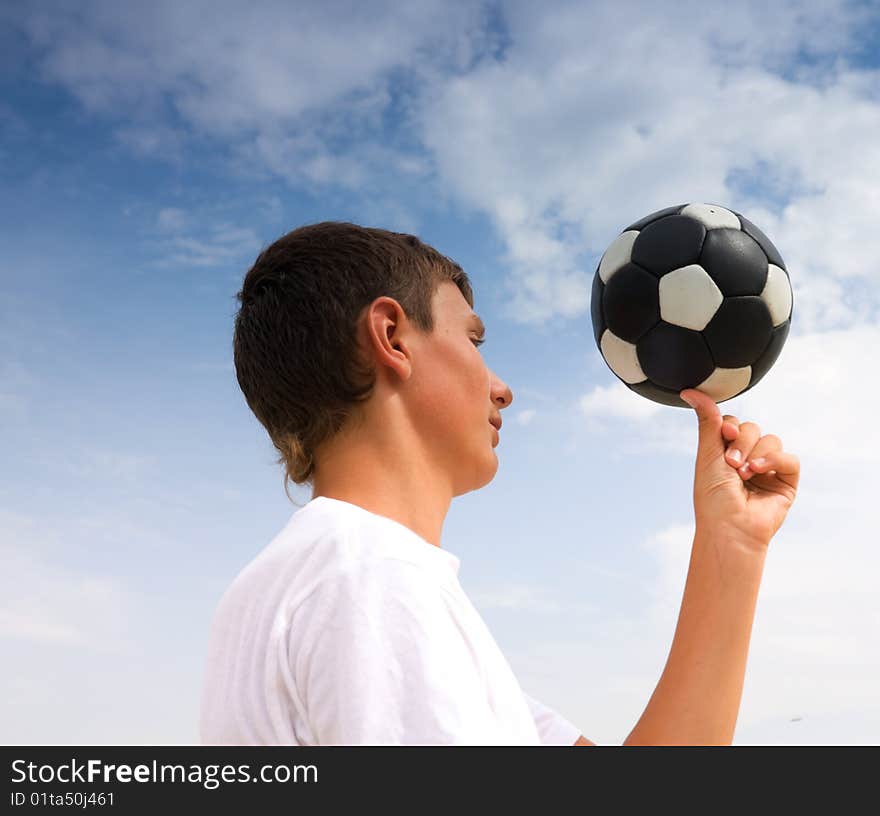 A teenager twists a ball