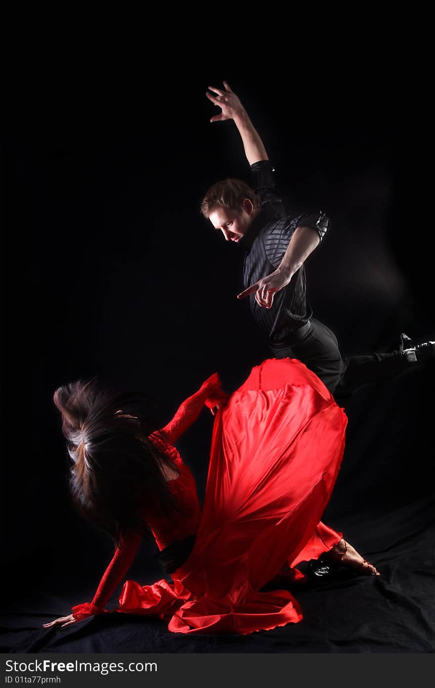 Dancers in action against black background