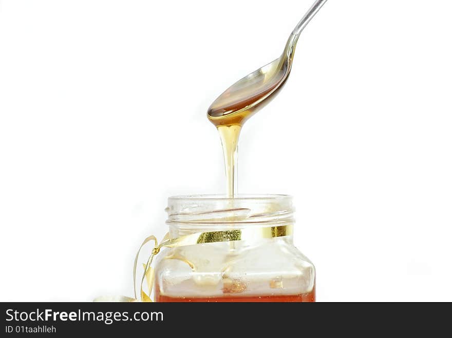 A jar of honey over white. A jar of honey over white