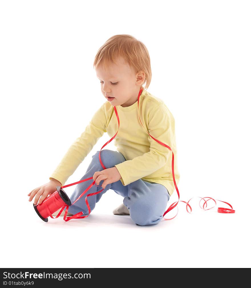 Portrait of adorable happy boy with reel of thread