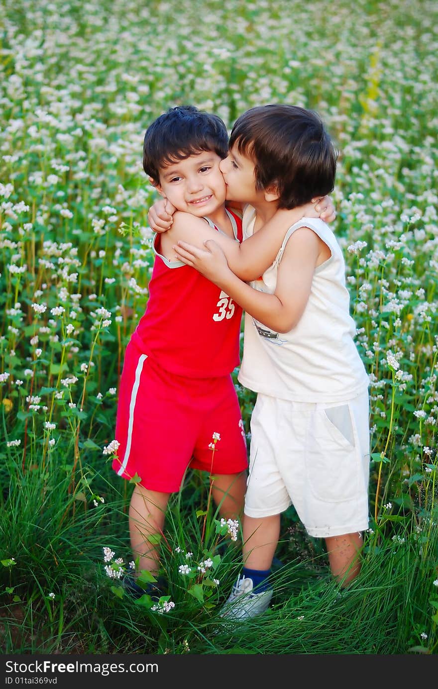 Two little brothers kissing each other