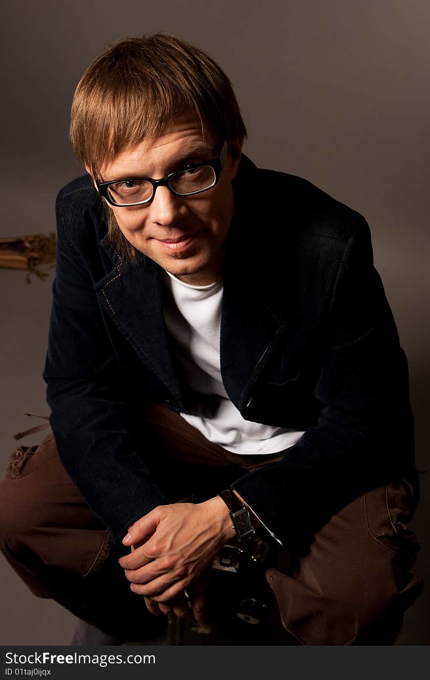 Smiling handsome in glasses isolated over gray