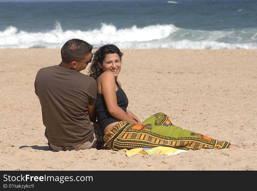 Attractive lovely couple relaxing on the beach. Attractive lovely couple relaxing on the beach