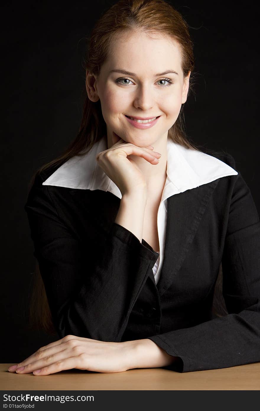 Portrait of businesswoman sitting by the table