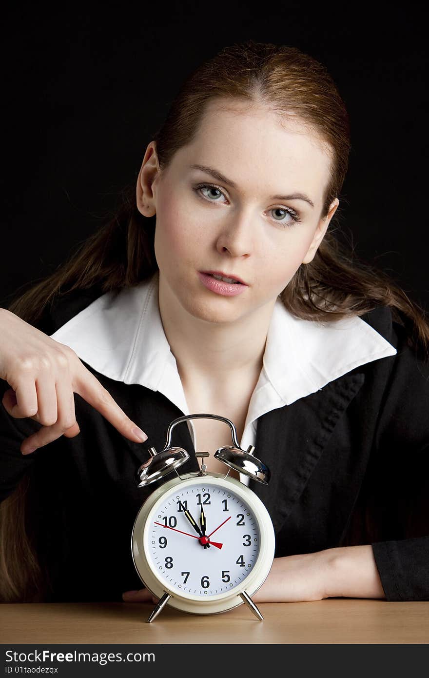 Portrait of businesswoman with an alarm clock