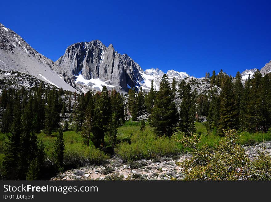 A mountain is captured under a cloudless sky in the high sierra. A mountain is captured under a cloudless sky in the high sierra