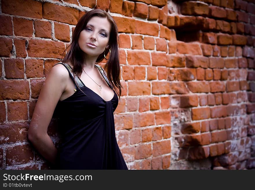 Charming Woman Near Brick Wall