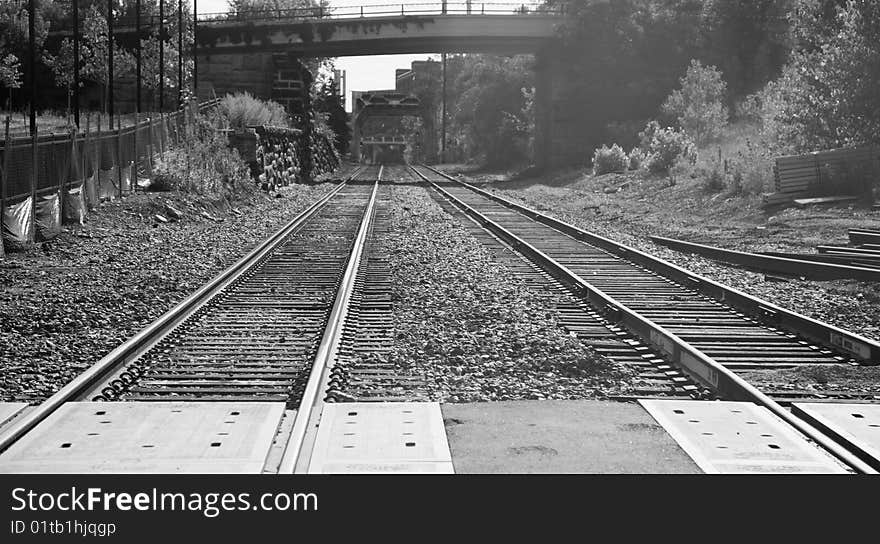 Railroad tracks under and then over a bridge through Minneapolis