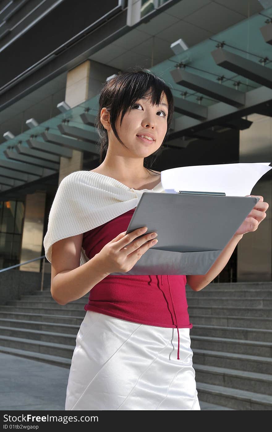 Beautiful young and modern Asian woman in the city. Beautiful young and modern Asian woman in the city.