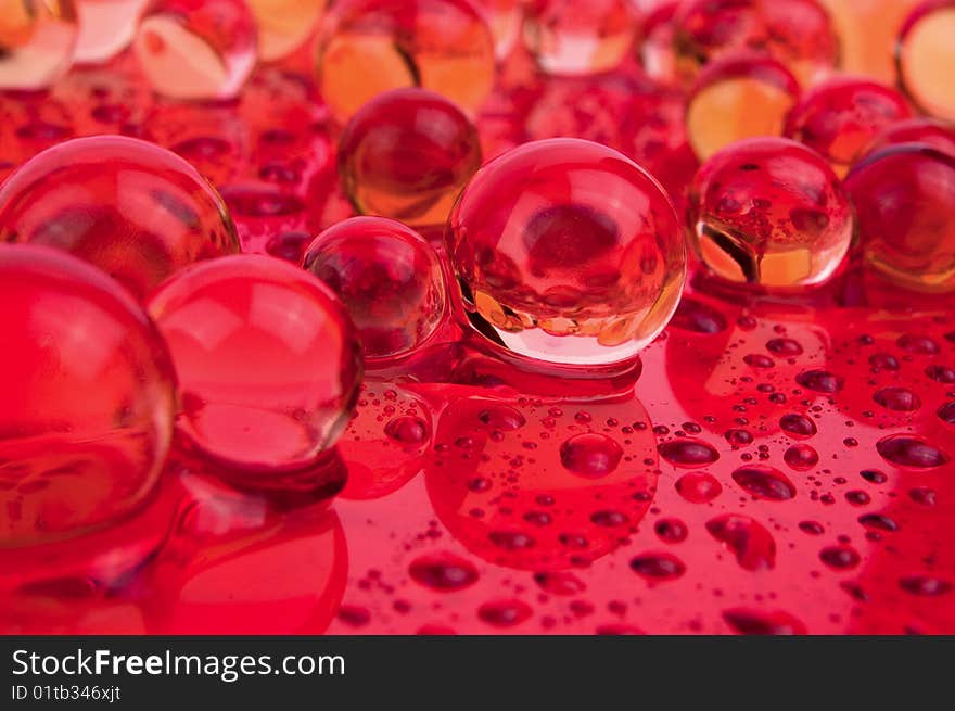 Balls and drops water on red surface. Balls and drops water on red surface