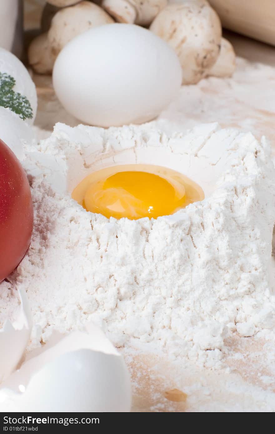 Close up shot of egg on heap of flour