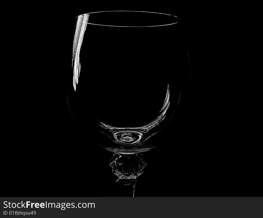 Empty wine glass on black background.