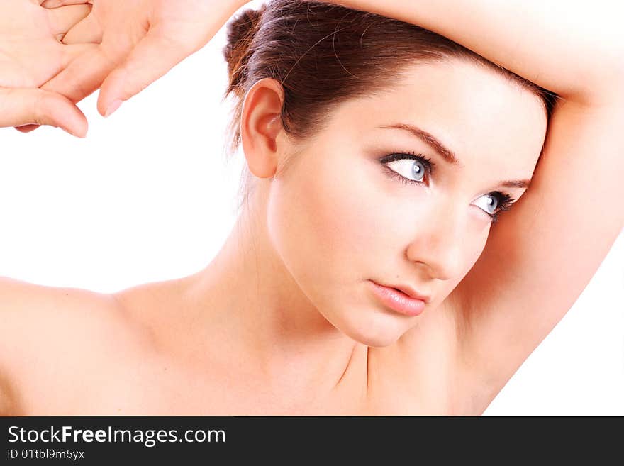 A beautiful young woman with her arms up in a contemplating pose. A beautiful young woman with her arms up in a contemplating pose.