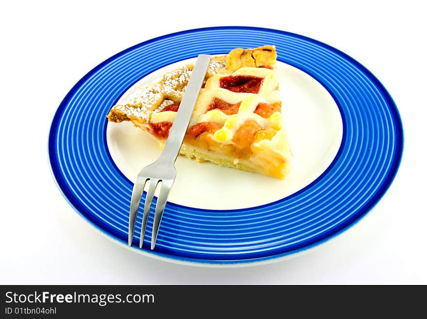 Slice of strawberry and apple pie on a blue plate with a small fork on a white background. Slice of strawberry and apple pie on a blue plate with a small fork on a white background