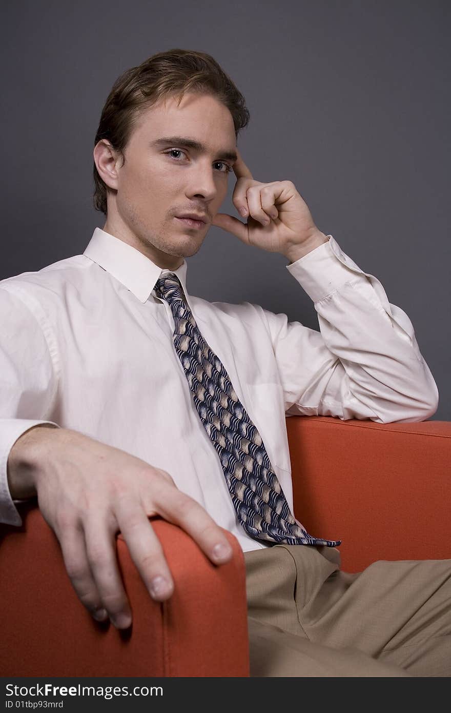 A middle aged business man isolated on dark background. A middle aged business man isolated on dark background.