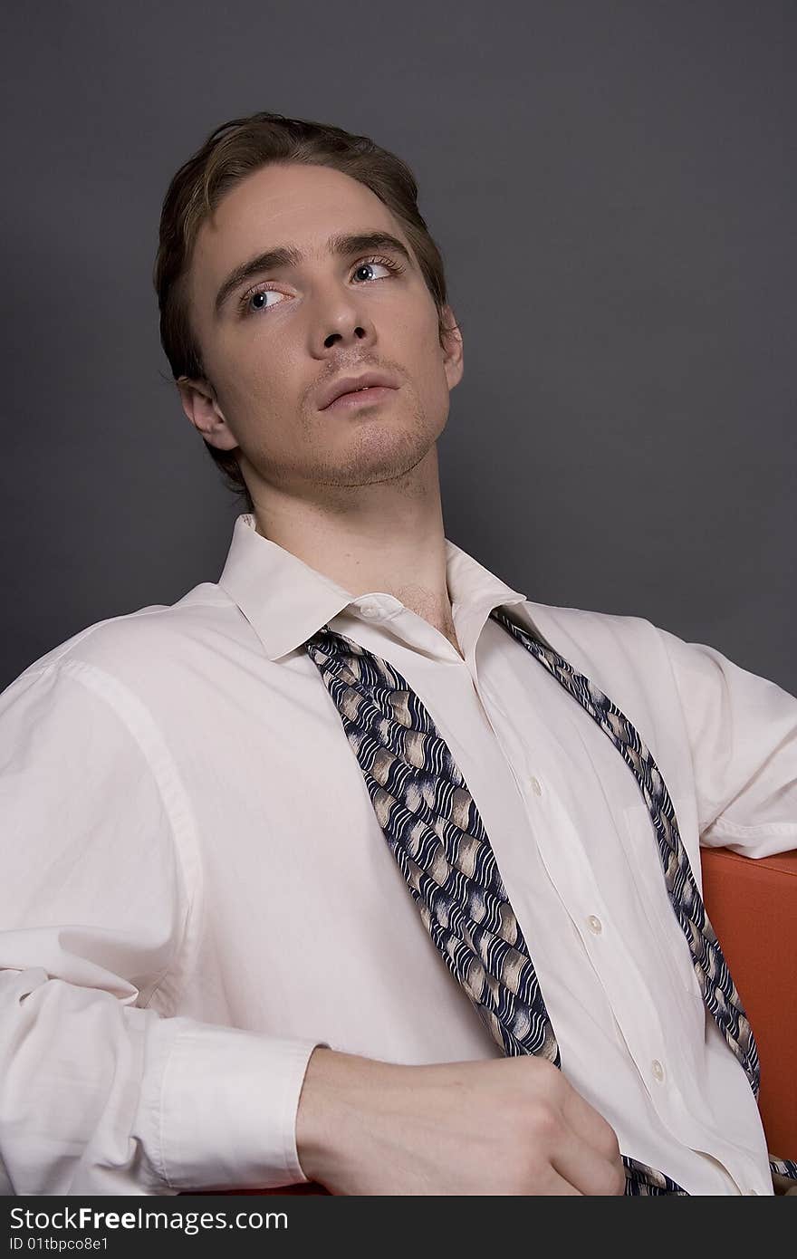 A middle aged business man isolated on dark background. A middle aged business man isolated on dark background.