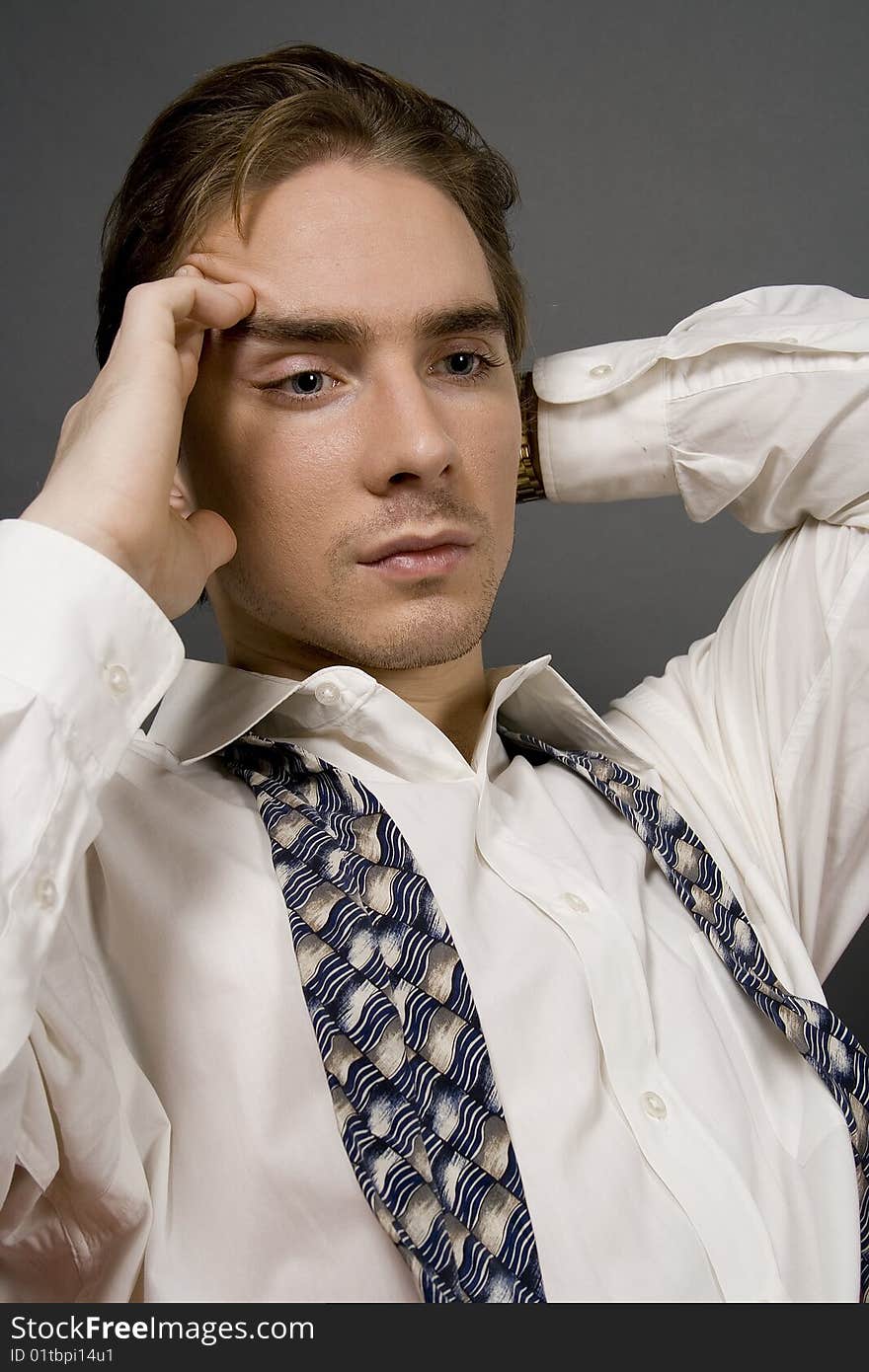 A middle aged business man isolated on dark background. A middle aged business man isolated on dark background.