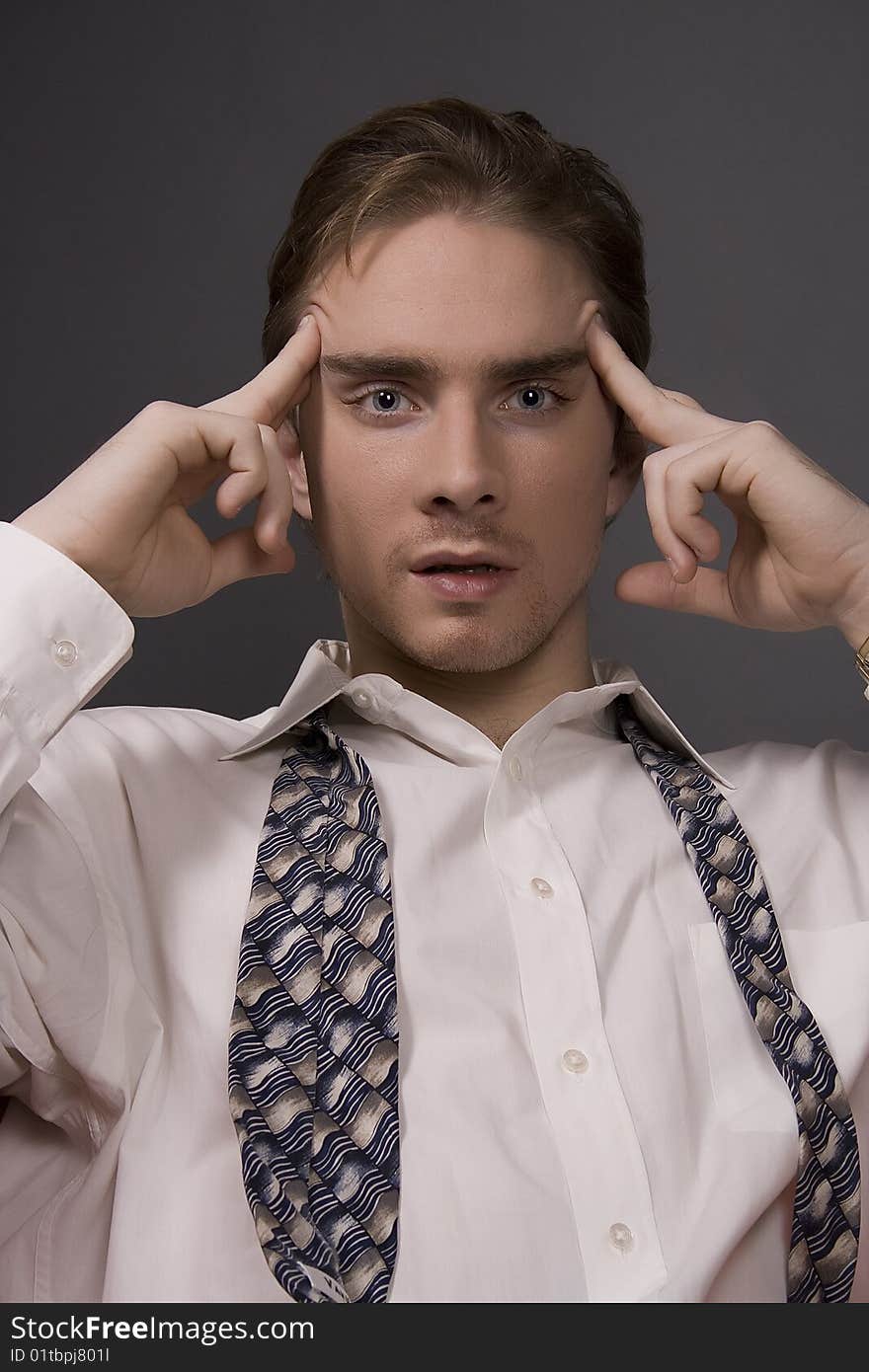 A middle aged business man isolated on dark background. A middle aged business man isolated on dark background.