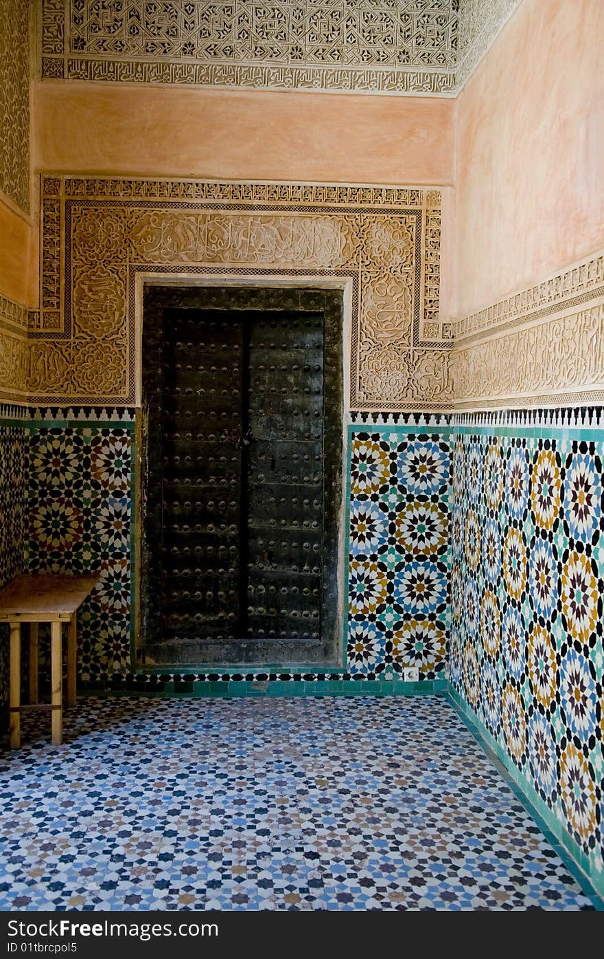 An ornate door surround by designed Moroccan tile on the walls. An ornate door surround by designed Moroccan tile on the walls.