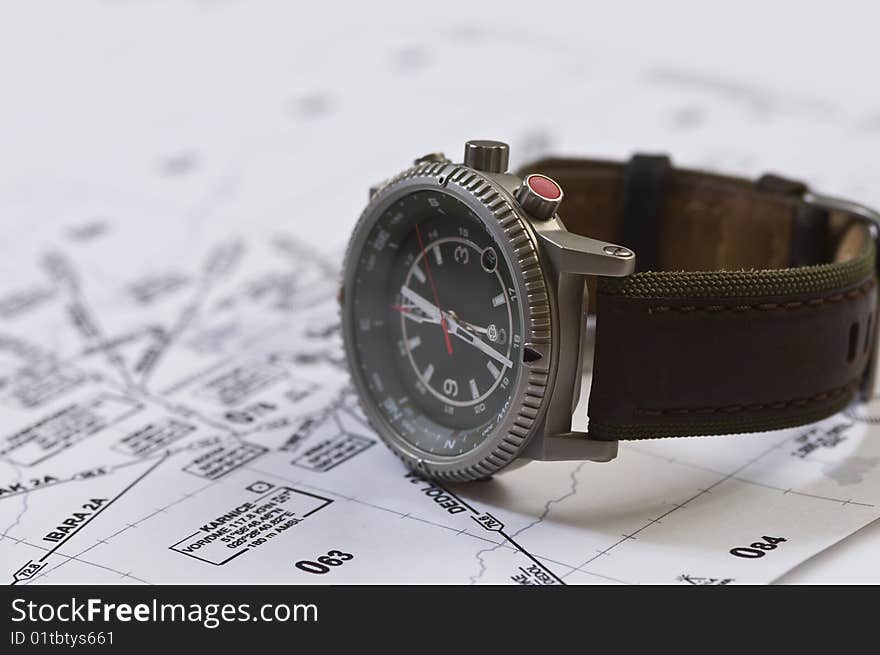 Watch compass and map on table