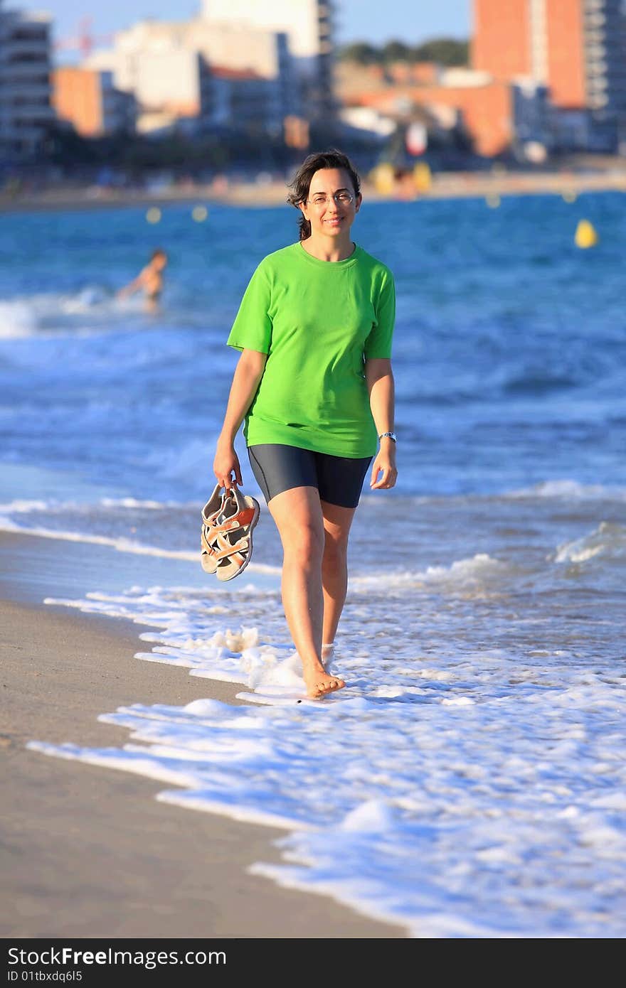 Happy woman walks close to the sea. Happy woman walks close to the sea