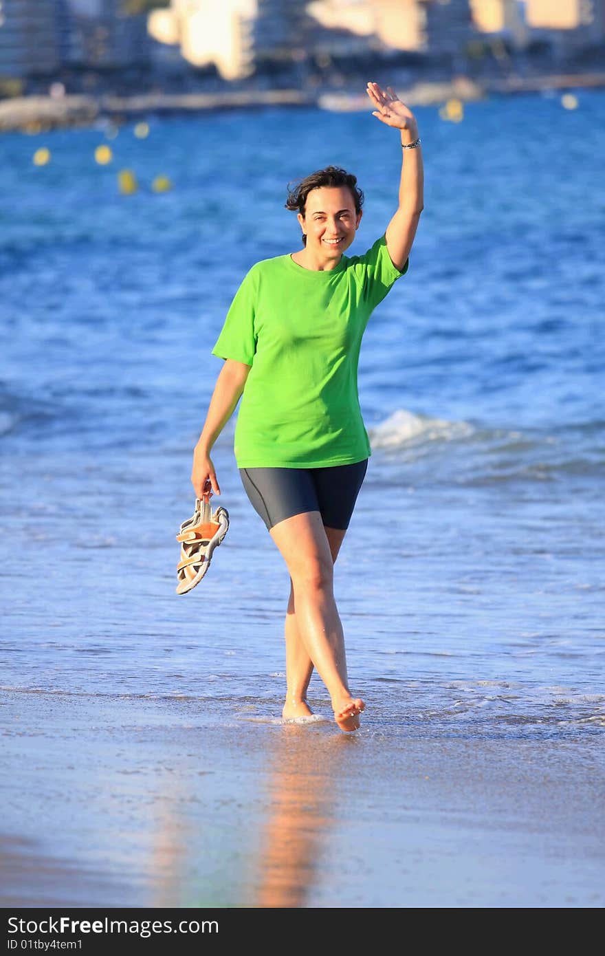 Happy woman walks close to the sea. Happy woman walks close to the sea