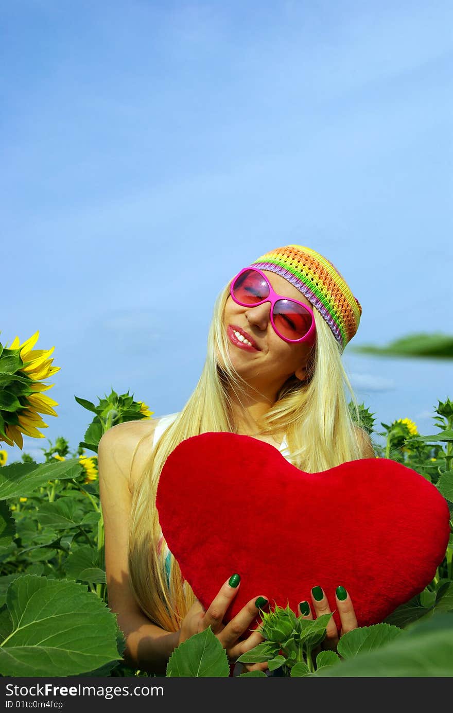 Pretty girl in pink glasses of sunflower. Pretty girl in pink glasses of sunflower