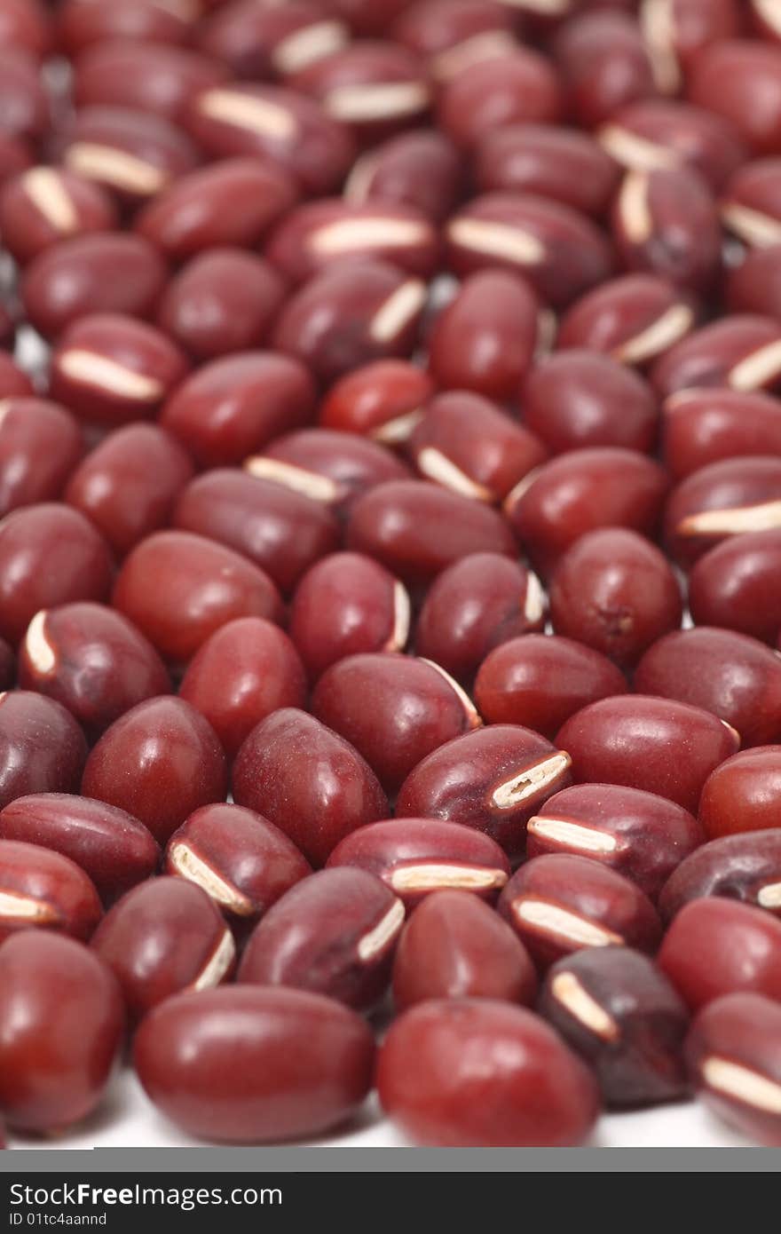 Some Red beans in the black background